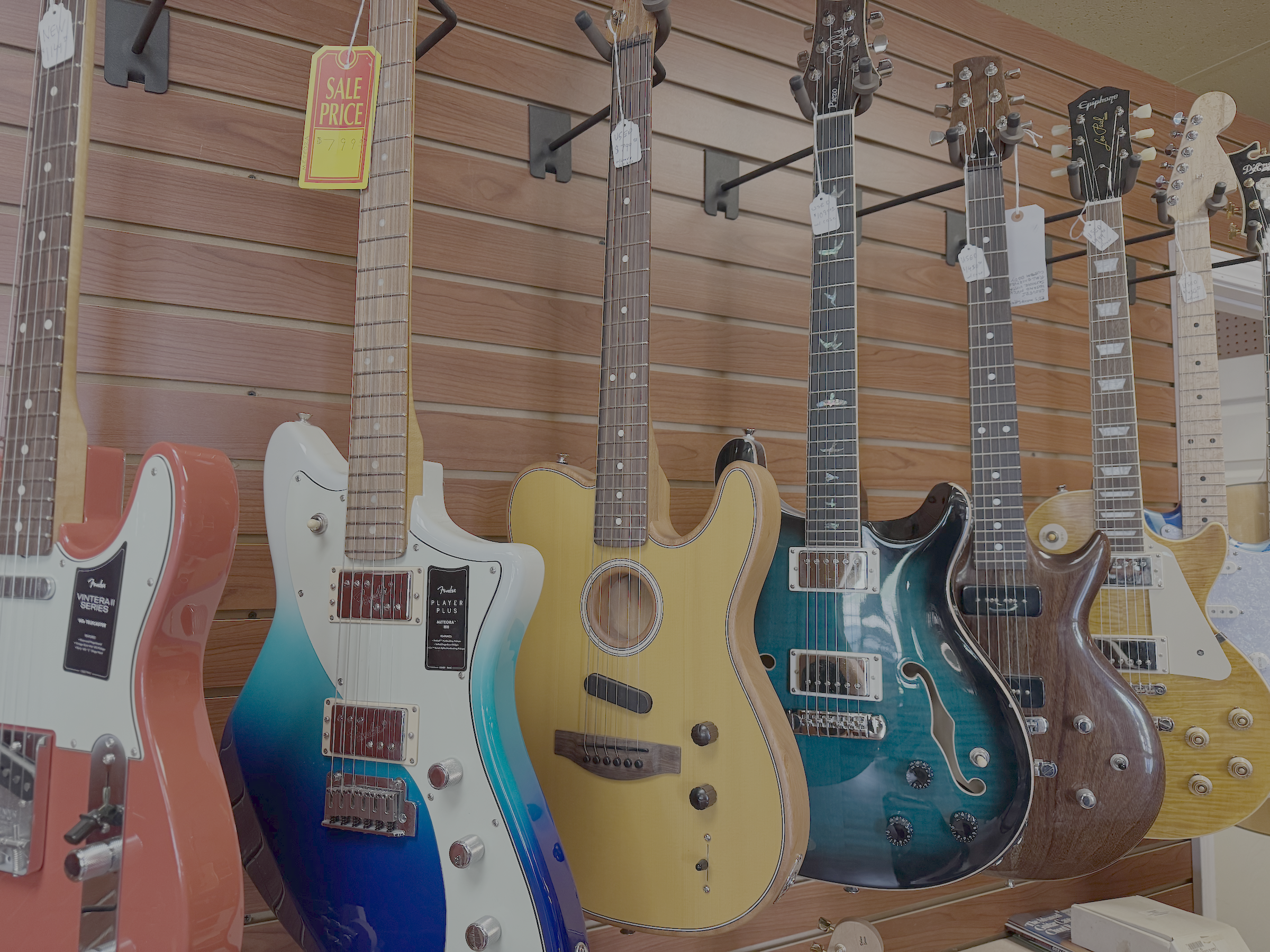 lots of high end guitars on the wall